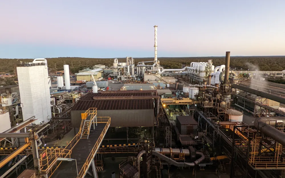 A processing plant at dusk, photographed from an elevated walkway